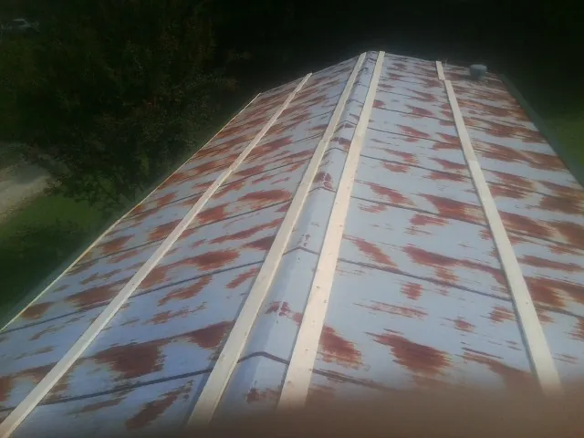 Rusted metal roof panels with new wood purlins before replacement — Storm Damage Roof Repair in Gattman by Roofing Brothers